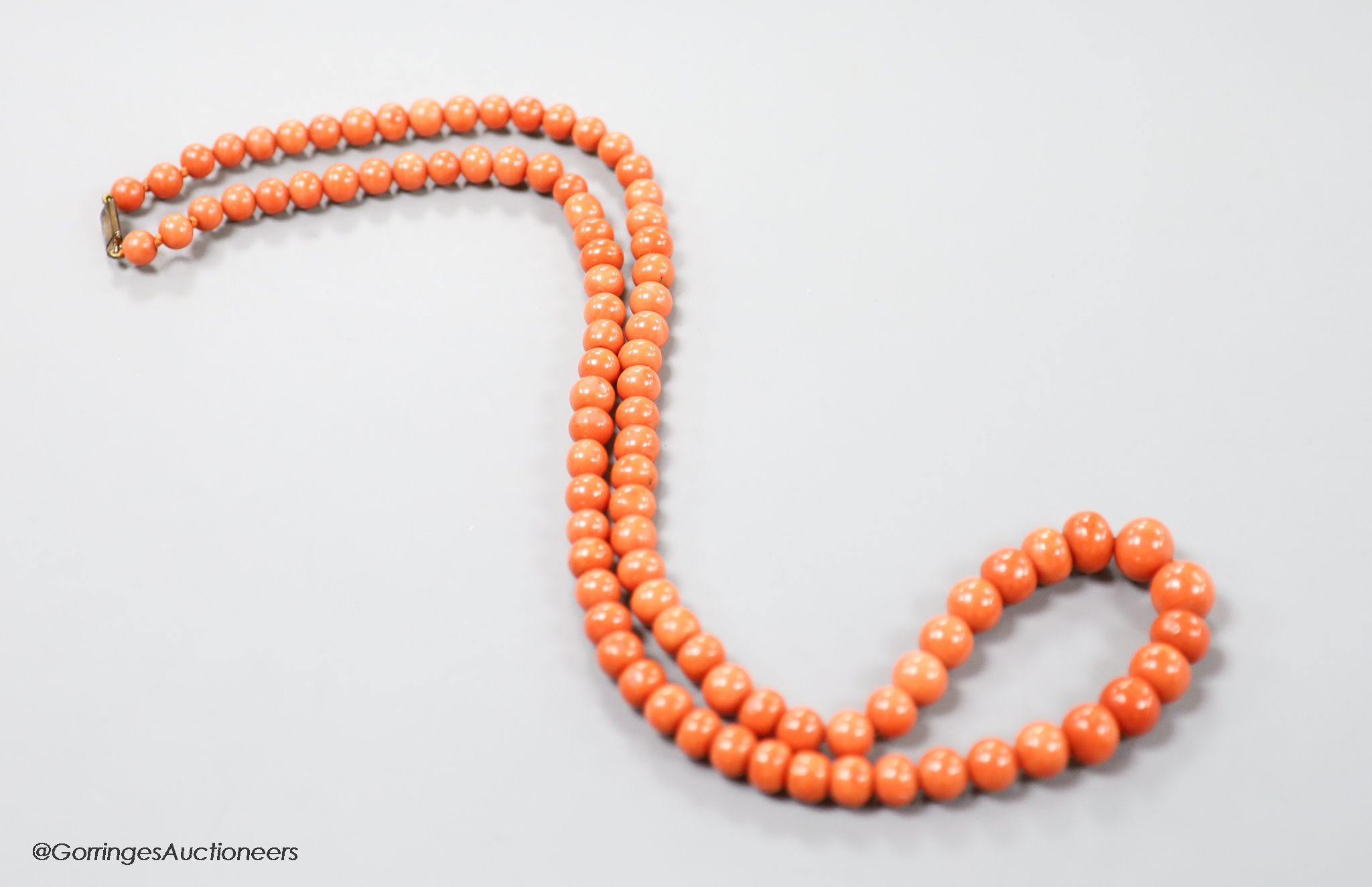 A large single strand graduated coral bead necklace, with yellow metal clasp, 80cm, gross weight 123 grams